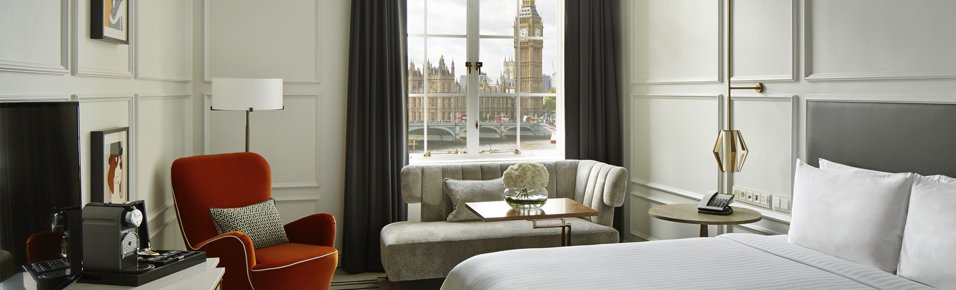 Interior of a room at London Marriott Hotel County Hall. Big Ben is visible through the window.