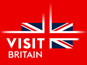 A logo of a stylised Union Jack flag on a red background with the words Visit Britain in white font on the lower left side.