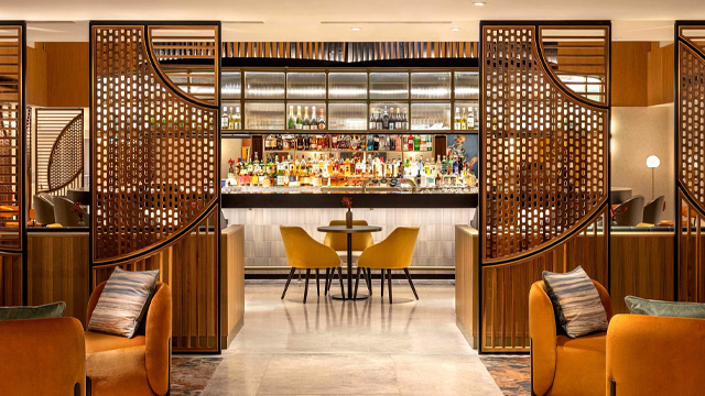 An interior of a brightly lit modern restaurant with a minimalist design and wooden features.