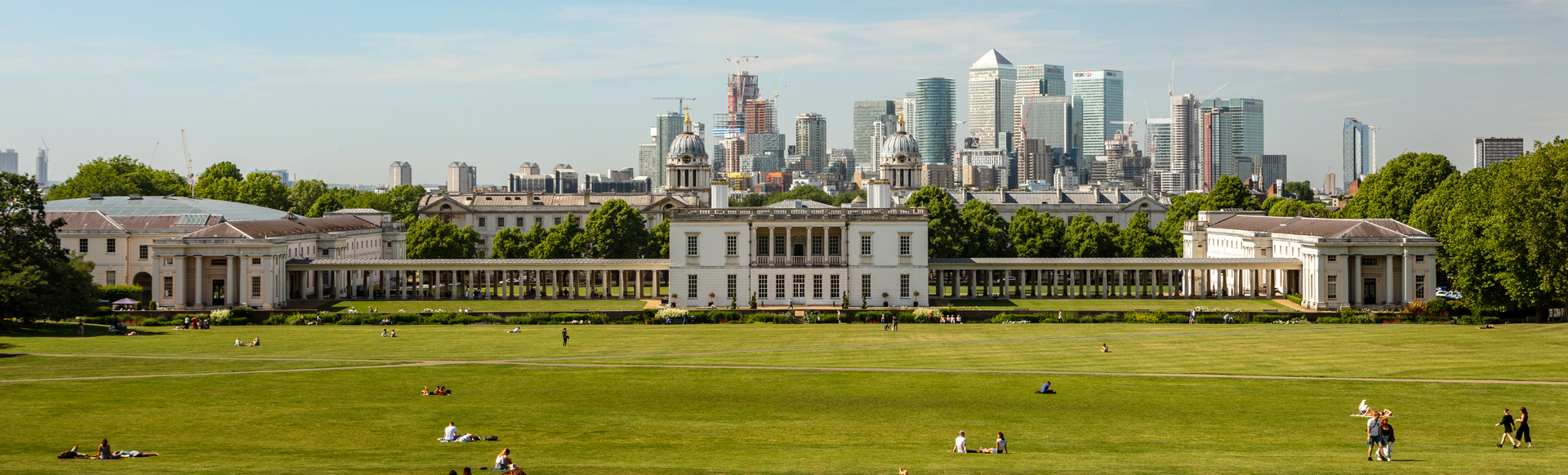Greenwich Royal Naval College in the centre of the big green park area with the London skyline in the background.