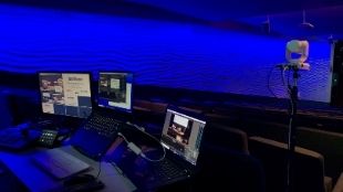 Studio setup at the Barbican in London, showing three monitors and a camera.