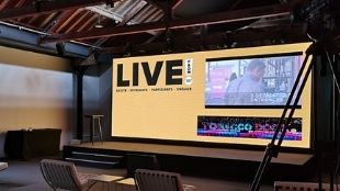 A big screen and small stage at Tobacco Dock in London.