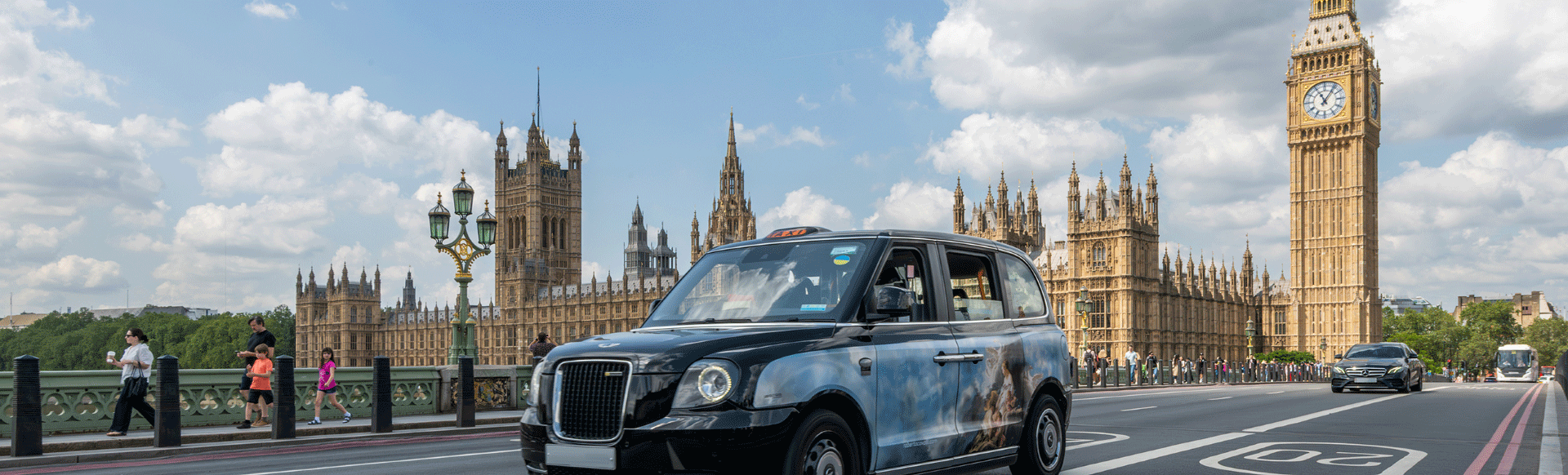 Taxi drives over Westminster Bridge on bright day with Big Ben and Houses of Parliament in background