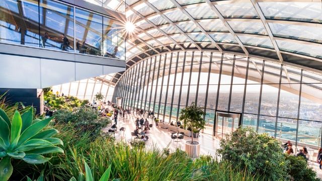 Top floor at the Sky Garden, with a great view over London and the cafe area with green plants.