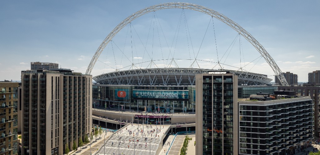 Exterior view of Wembley Stadium in London. Crowds arrive to watch a UEFA EURO 2020 match.