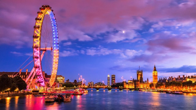 London skyline at dusk with Big Ben and the London Eye.