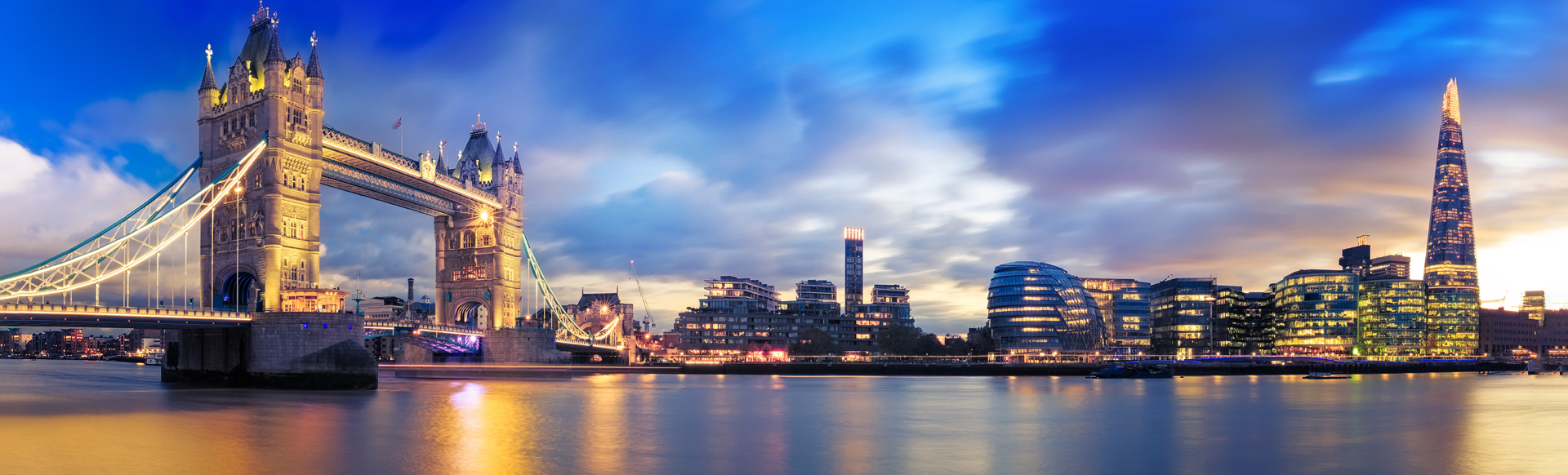 View of Tower Bridge, the Shard and the river Thames at sunset in London.