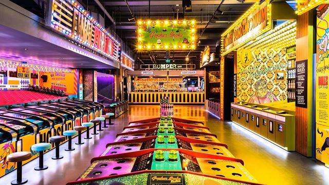 Have old-school fun at Fairgame. Credit: Fairgame. Image courtesy of Fairgame. Brightly coloured old-school arcade games with yellow, purple and green lights.