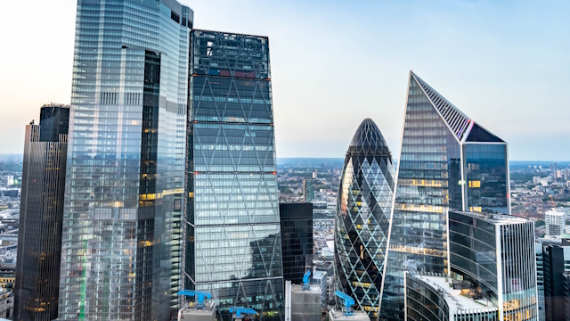 Skyscrapers in the City of London including The Gherkin on a clear day with the city in the background.