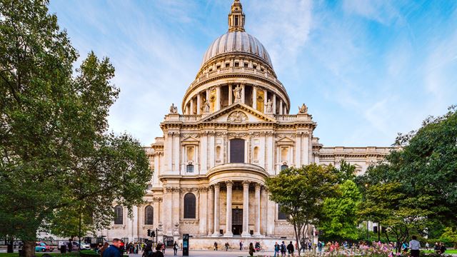 St Paul's Cathedral. Credit: Jon Reid. Image courtesy of visitlondon.com. St Paul's Cathedral on a clear sunny day with blue sky and people walking past and up to the entrance.