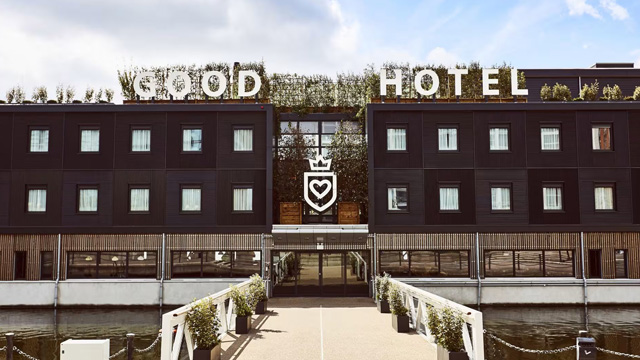 Exterior of a brown building with a sign that reads Good Hotel