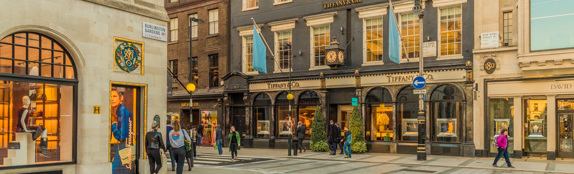 Shoppers walking past luxury stores including Tiffany&Co in Mayfair.
