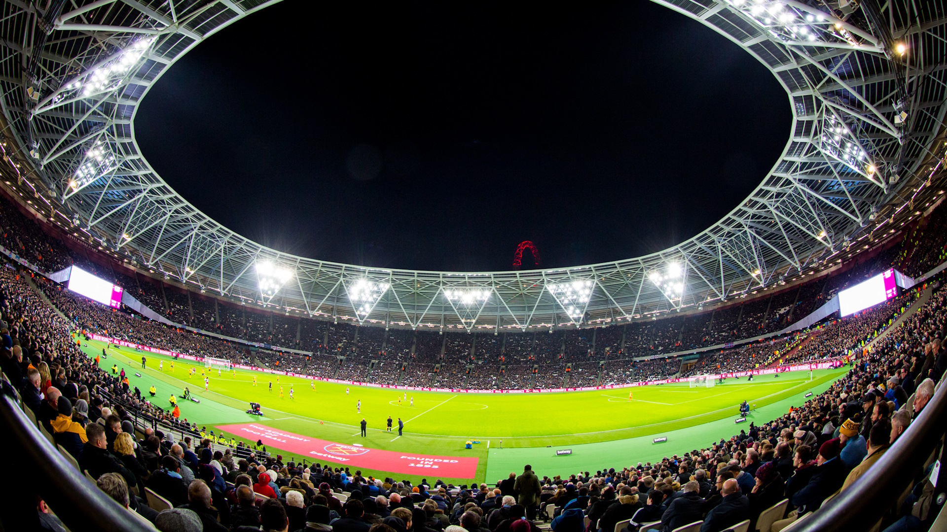 Arsenal game at the London Stadium at night.