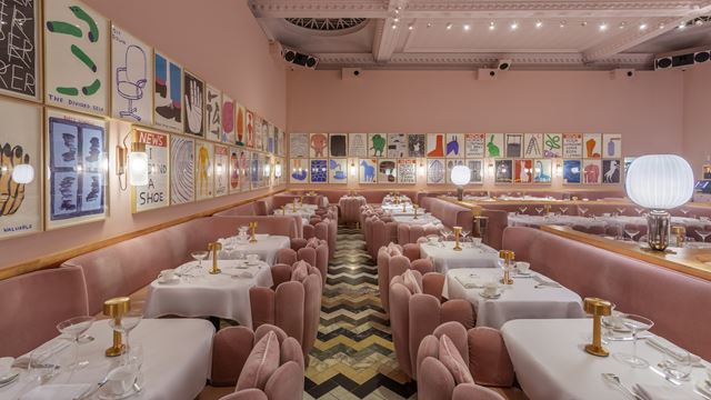 Experience Sketch on Conduit Street. Credit: Sketch. Image courtesy of Sketch. The pink room with velvet pink seats at Sketch, tables with white tablecloth and artwork adorning the walls.