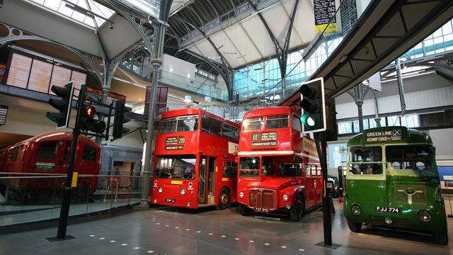Visit the fascination London Transport Museum. Credit: London Transport Museum. Image courtesy of London Transport Museum. Two red double-decker buses and one smaller green bus on display inside the London Transport Museum.