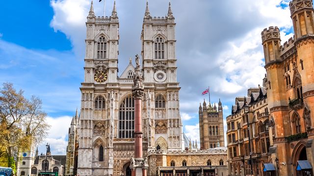 Westminster Abbey. Credit: Shutterstock. Image courtesy of Shutterstock. Facade of Westminster Abbey on a sunny day with blue sky and some clouds.