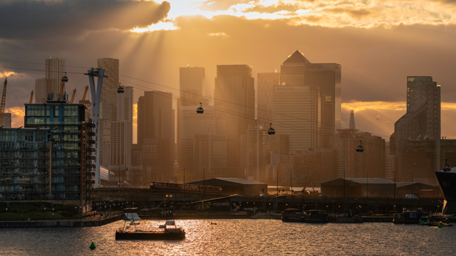 A view at sunset of the docklands and river Thames with Canary Wharf skyscrapers in the background.