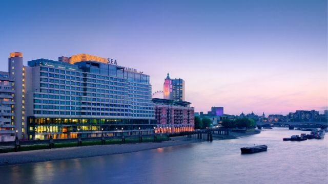 Sea Containers building at sunset with the riversinde in front.