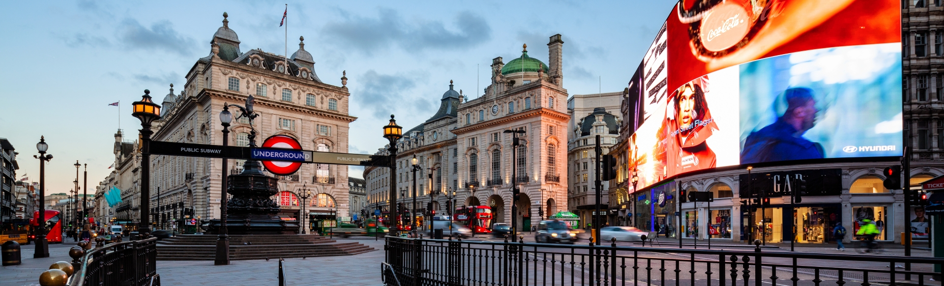 The bright lights of Piccadilly Circus as seen from the steps of the Piccadilly tube station.