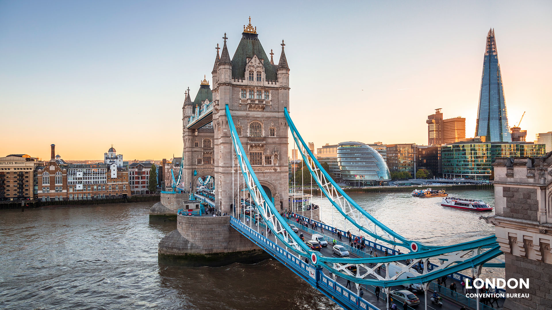 Close up view of Tower Bridge across the river with cityhall and the Shard in the background.