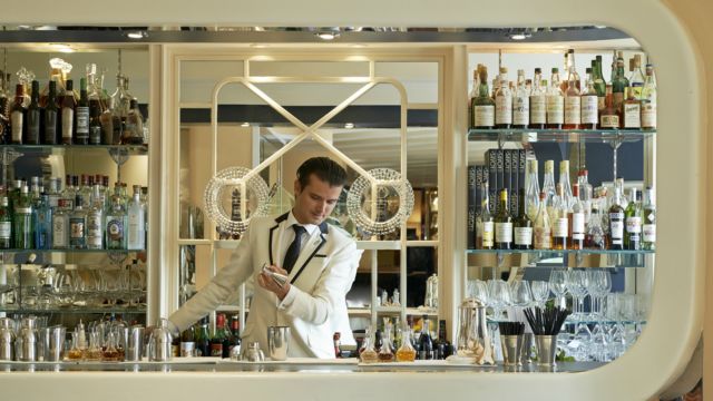 The American Bar at The Savoy. Credit: The Savoy. Image courtesy of The Savoy. A mixologist creates a cocktail at the american bar at the savoy hotel in london.